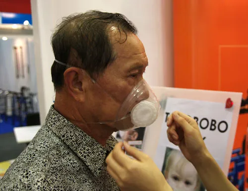 visitor trying out Totobobo mask visitor trying out Totobobo mask