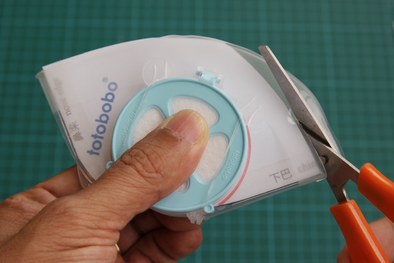 Use the paper dummy as a guide, cut the mask with a pair of scissors. (The simple scissor shown in the photo is very good for cutting Totobobo mask)