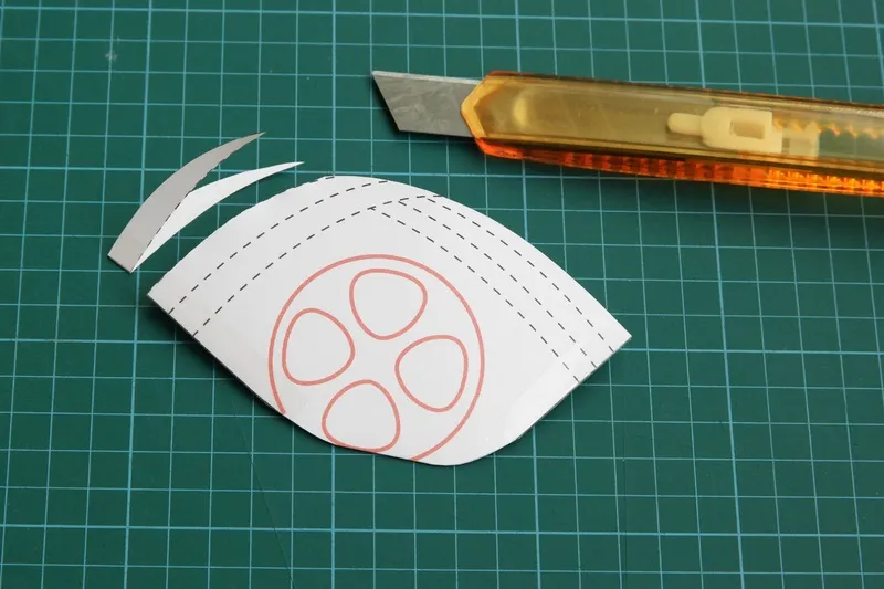 If the paper mask is too big, cut away the first line near to the chin-edge. Put it on the user's face again to test the size.